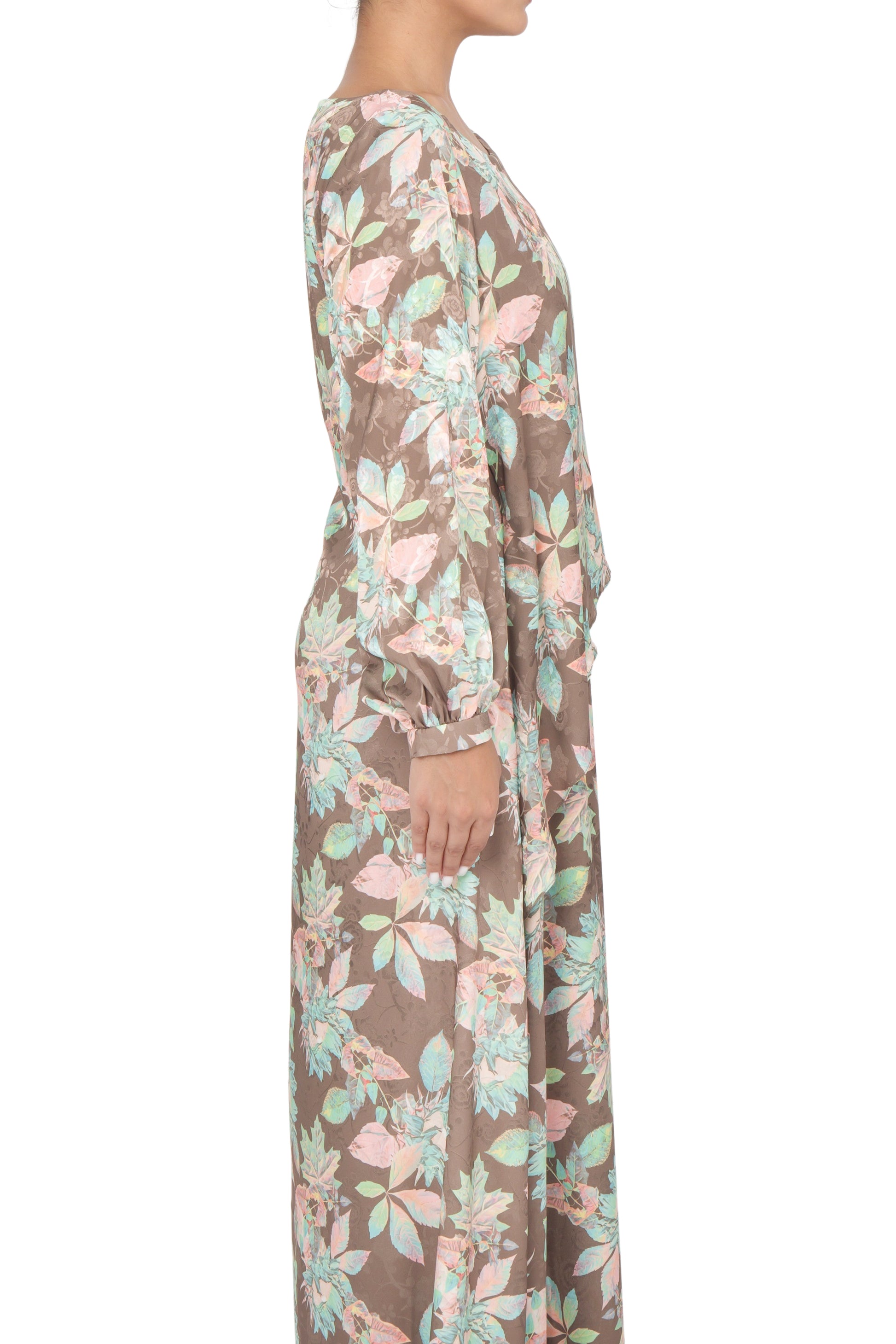 This silk dress features a comfortable and stylish design with tied puff sleeves and an overlay front panel, perfect for any fashion-forward woman.