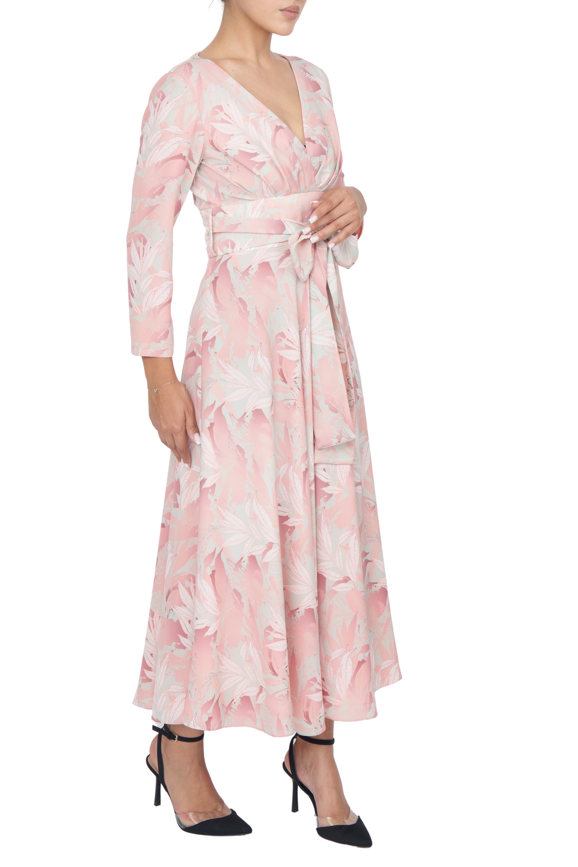 High-waisted panel of the peach floral dress tied at the front with a large bow