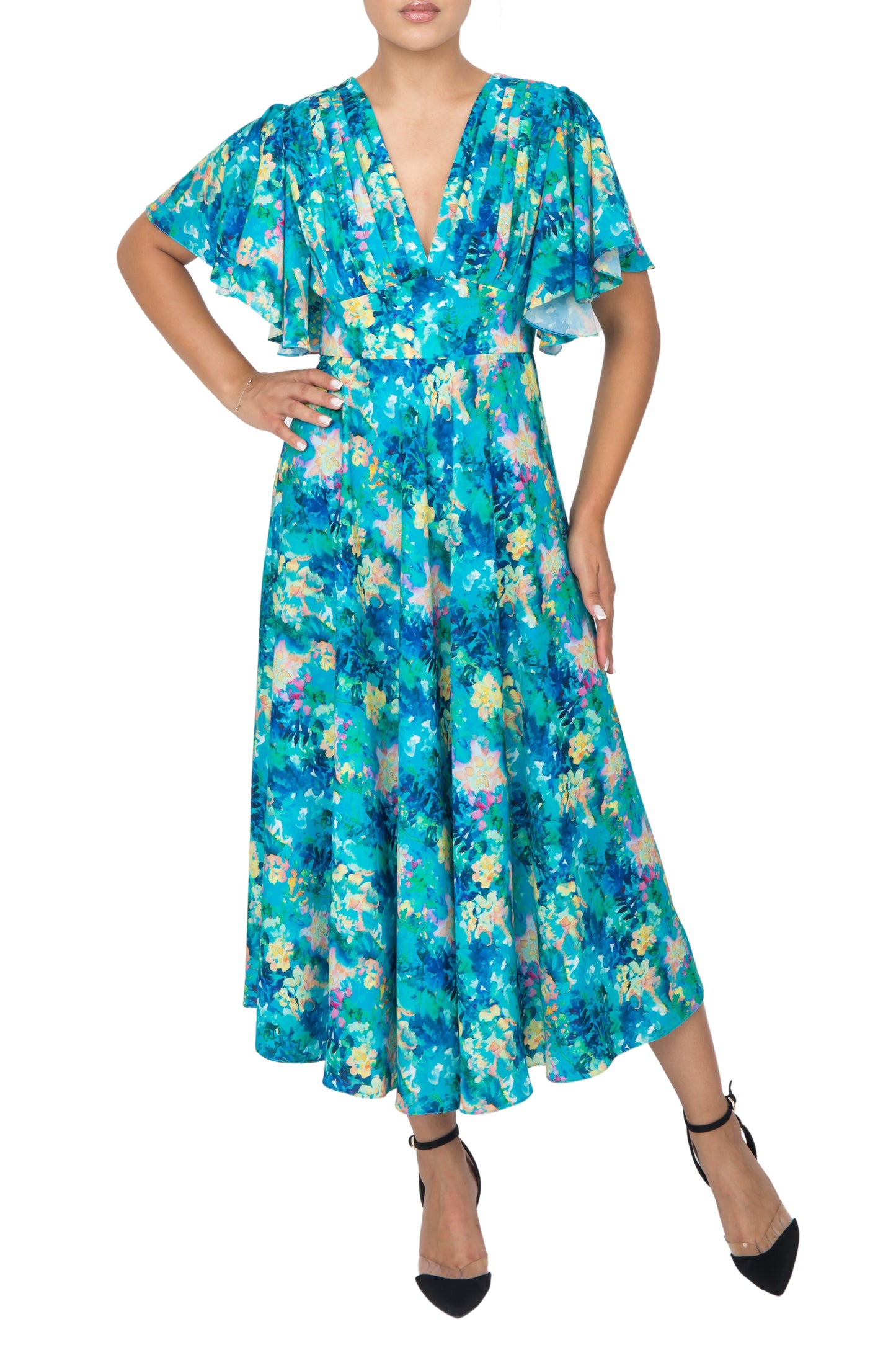 A model posing in a blue floral silk dress,