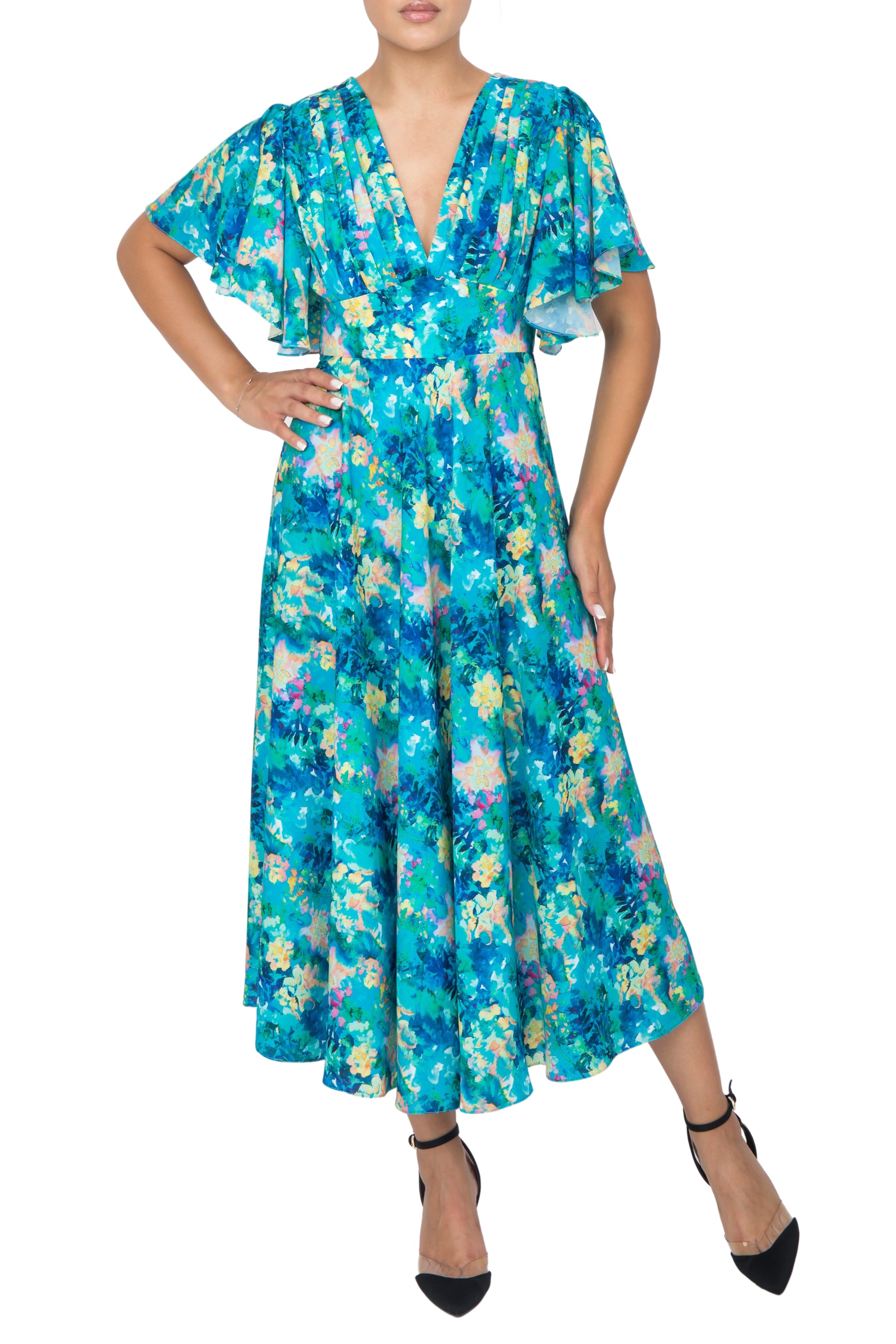 A model posing in a blue floral silk dress,