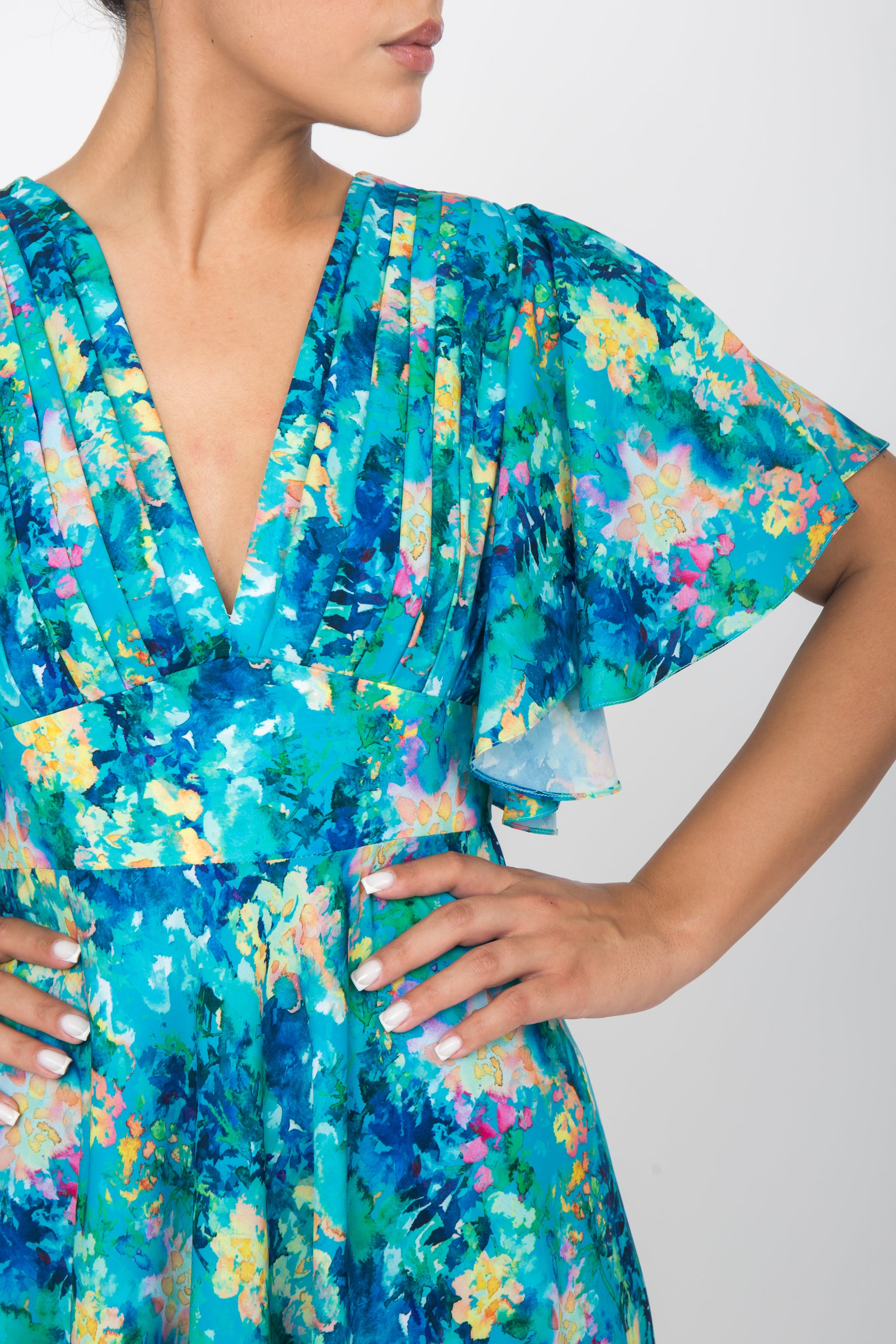 Close-up of loose fluted sleeves of blue floral silk dress