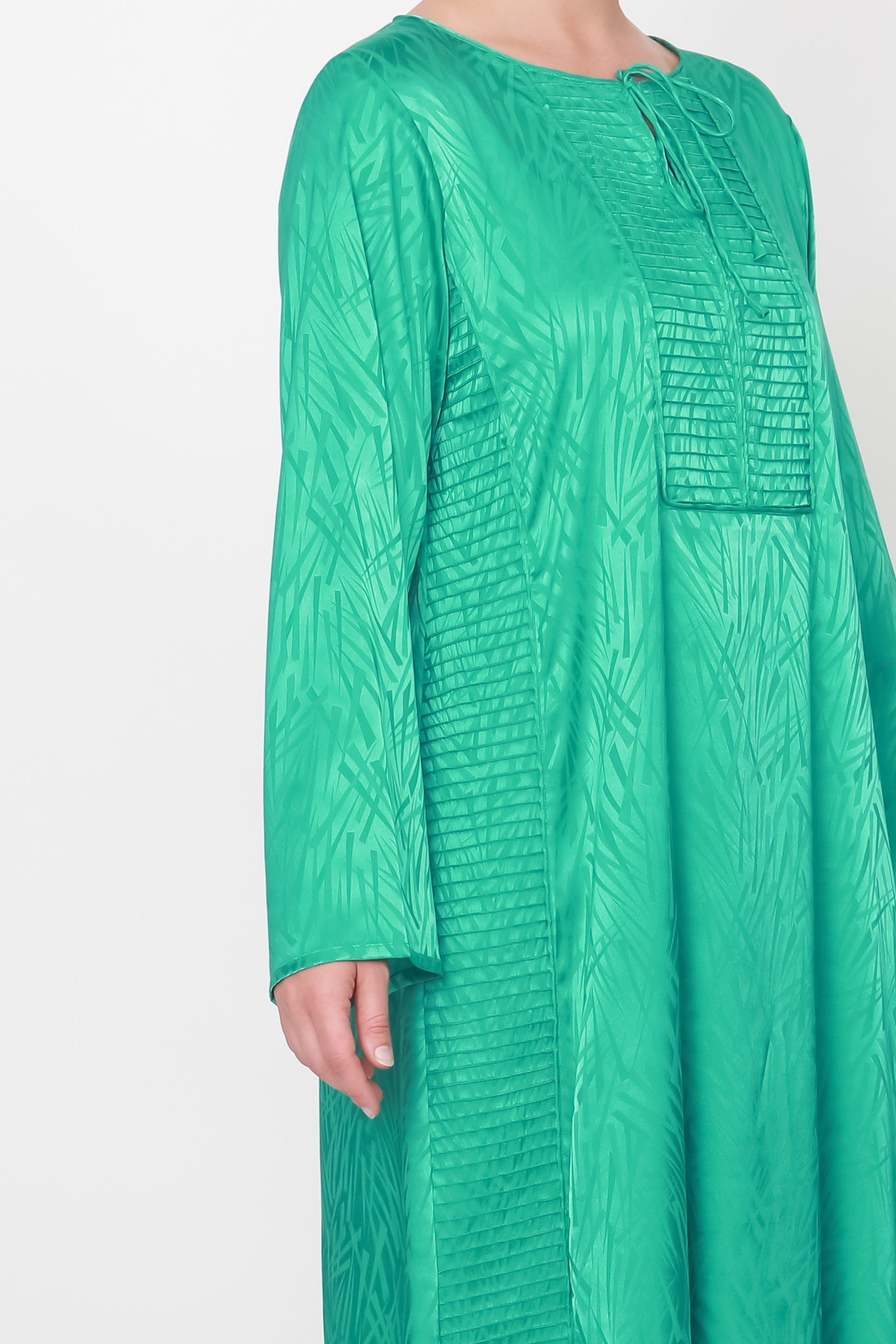 Green dress with unique design elements and comfortable loose sleeves