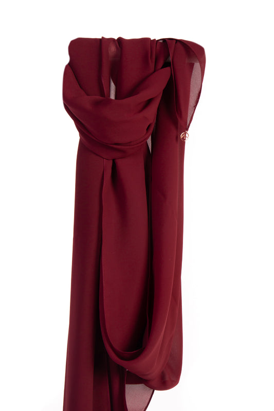 Image of a burgundy silk chiffon shayla draped elegantly, showcasing its soft and delicate texture and rich, luxurious color