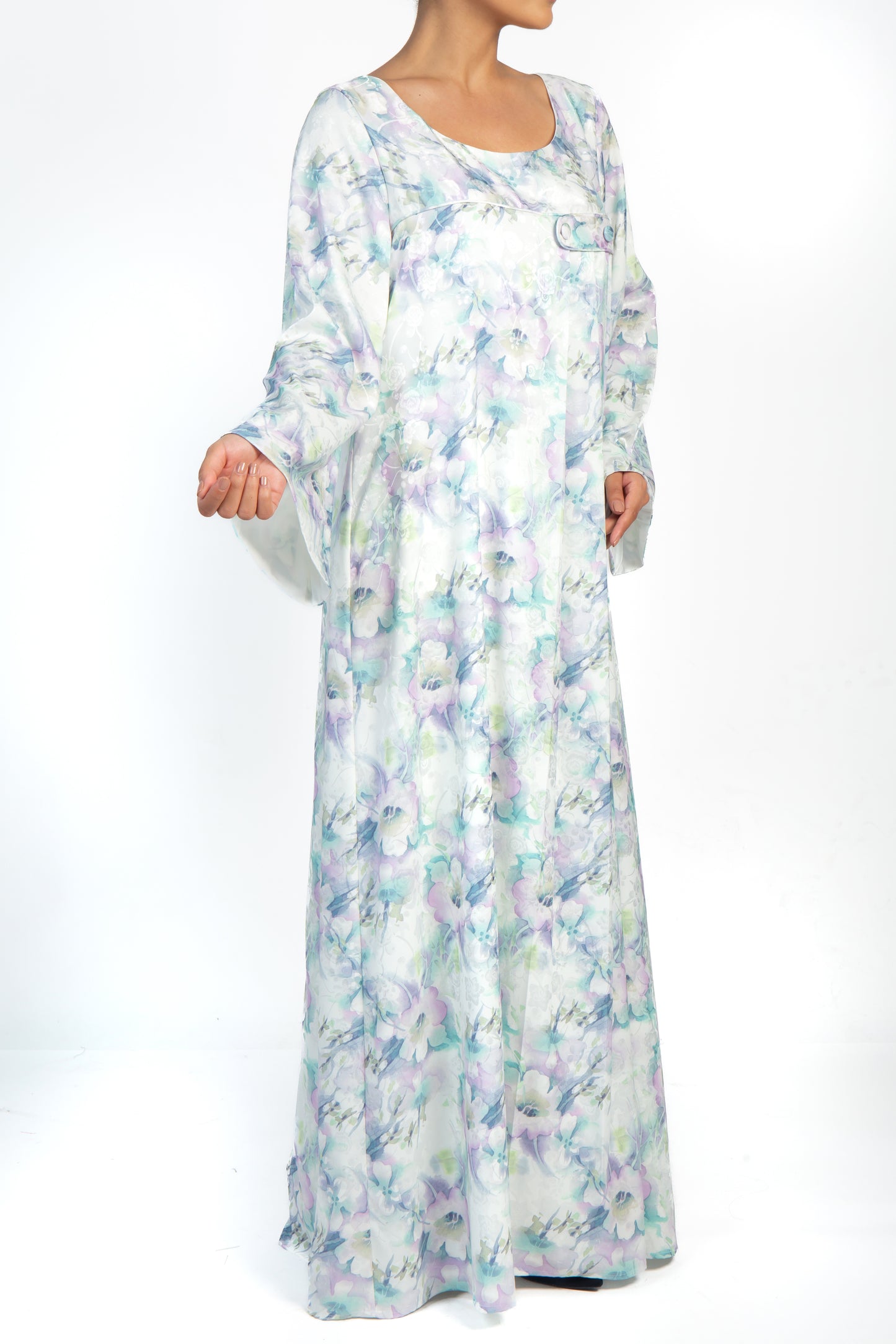 Elegant ivory and lilac print silk dress with loose-fitting silhouette and pleating detail. Perfect for a day out or a special occasion. Features long sleeves and covered buttons. Stay cool and comfortable in the light and airy material.