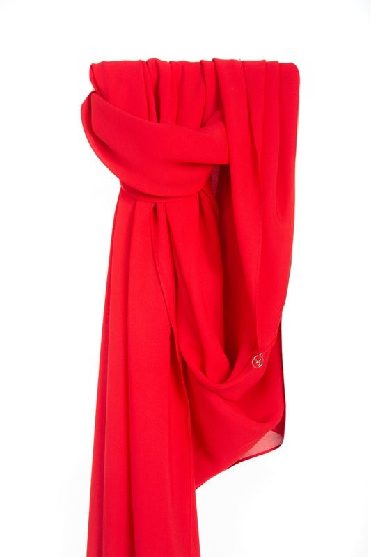 Image of a red silk chiffon shayla, draped elegantly with a soft and silky texture, showcasing its bold and vibrant red color.